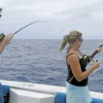 Joshua Ellison (left) and Caroline Boyd battle two king mackerel aboard QB’s Sea Witch at the Horseshoe area.