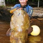 T.J. Penninger of New London, who learned “noodling” from Paul Cleveland, won a struggle with this 57-pound flathead.