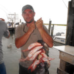 William Maxwell of Milton, Ct. holds a stringer of black sea bass and vermillion snappers that he and his friend caught from the Miss Hatteras on July 11, 2012.