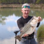 Mike McSwain shows another angle of the 12.5-pound bass Dave Miller cranked up on a KVD 2.5.
