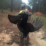 Brady Smouse walks off with his bounty for the day; he killed both turkeys with one shot.