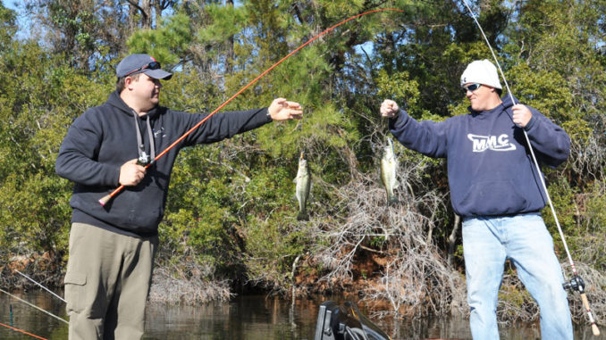 Jason Dew (bow) and Randall Soles catch two largemouth bass at Sutton Lake.