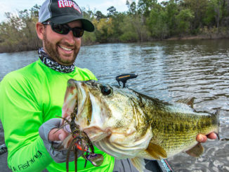Ott DeFoe, the 2019 Bassmaster Classic Champion and Major League Fishing pro angler, holds up a big bass caught on a Terminator Shuddering Bait.
