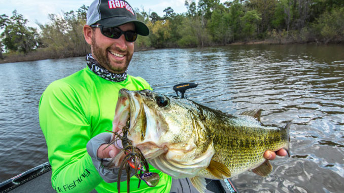 Ott DeFoe, the 2019 Bassmaster Classic Champion and Major League Fishing pro angler, holds up a big bass caught on a Terminator Shuddering Bait.