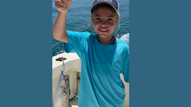 Tess McMichael, 9 years old, catches and releases her first Spanish mackerel on her first ocean fishing trip.