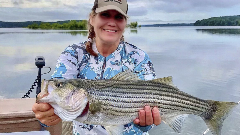 Tarra Stoddard is our Photo of the Week winner for the second week of August 2021, with an image of her and a Lake Hartwell striper.