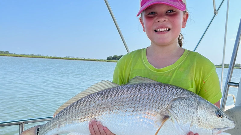 Seven year old Lauren Speer caught this 32-inch, 11-pound redfish in Folly River on August 13th, 2023.